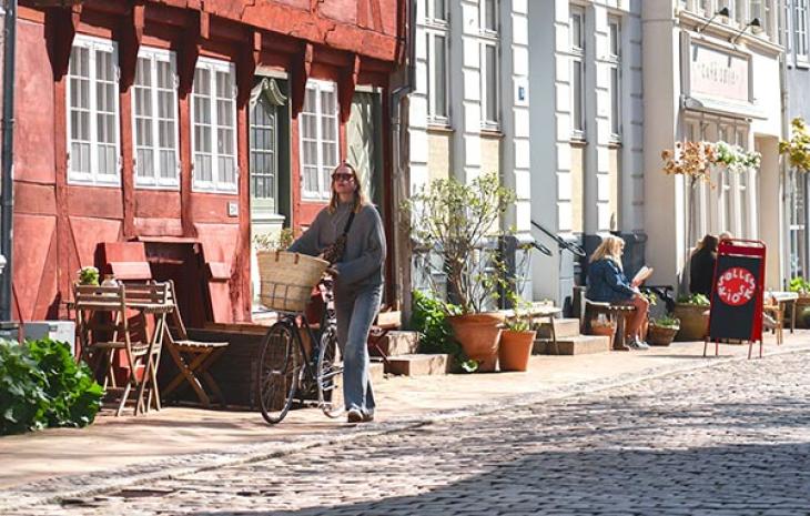 Pige trækker cykel i Nedergade